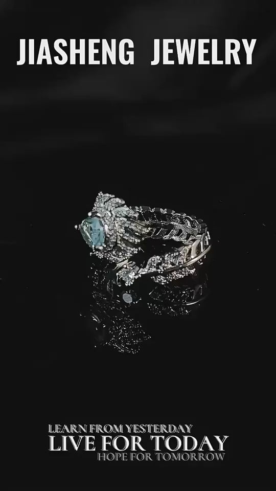 Eleganter Damenring im Feder-Design mit hellblauem Stein