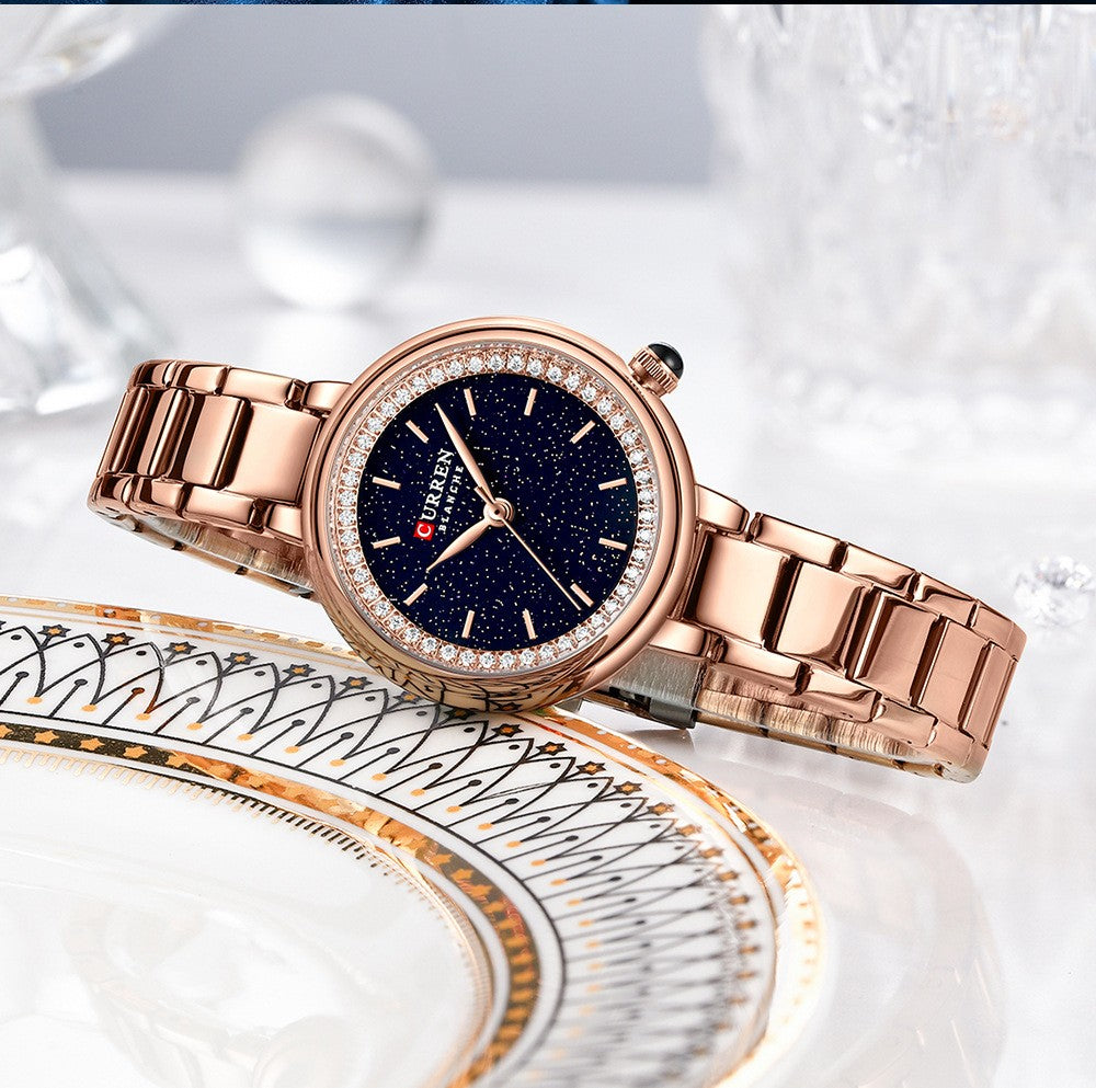 Elegant women's wristwatch with small dial and metal strap