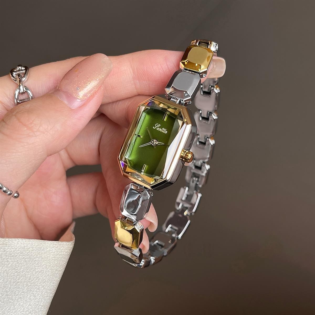 Elegant women's watch with small dial and metal strap