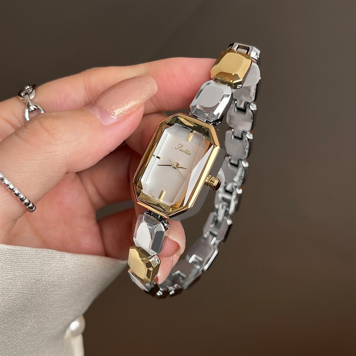 Elegant women's watch with small dial and metal strap