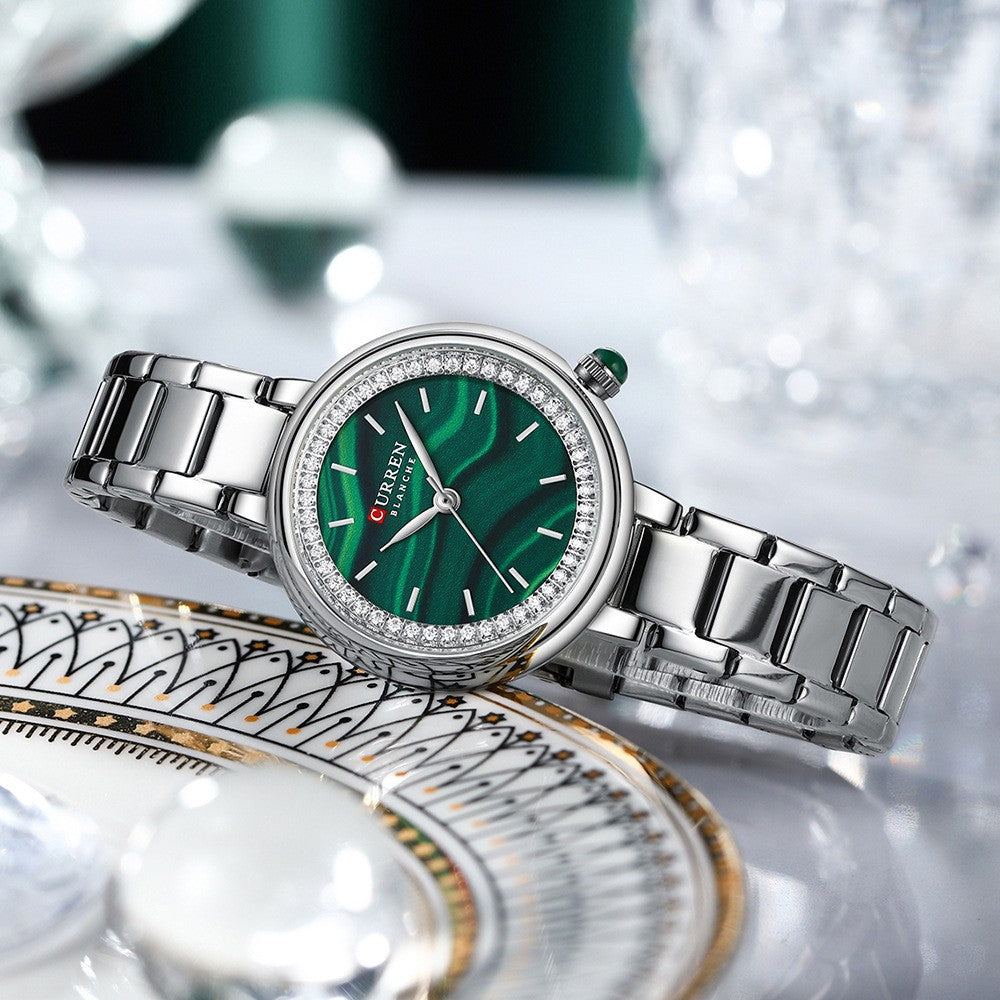 Elegant women's wristwatch with small dial and metal strap