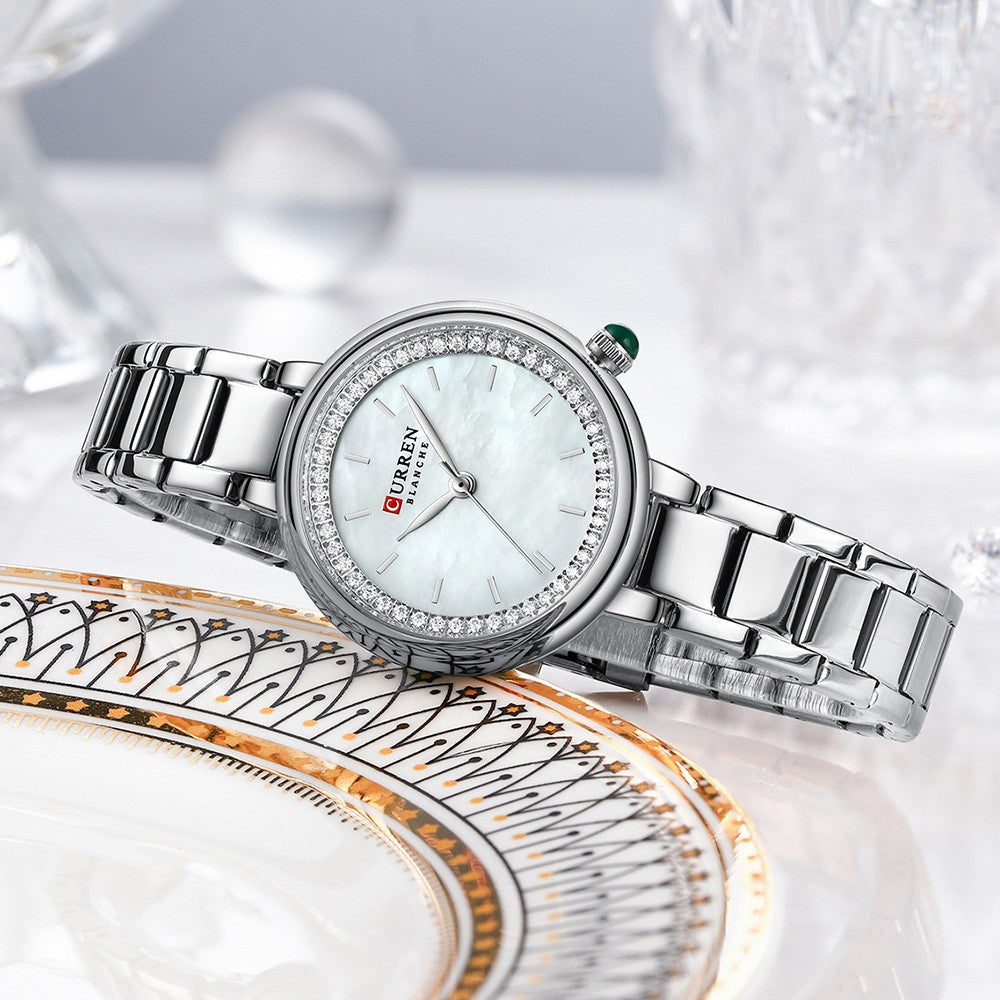 Elegant women's wristwatch with small dial and metal strap