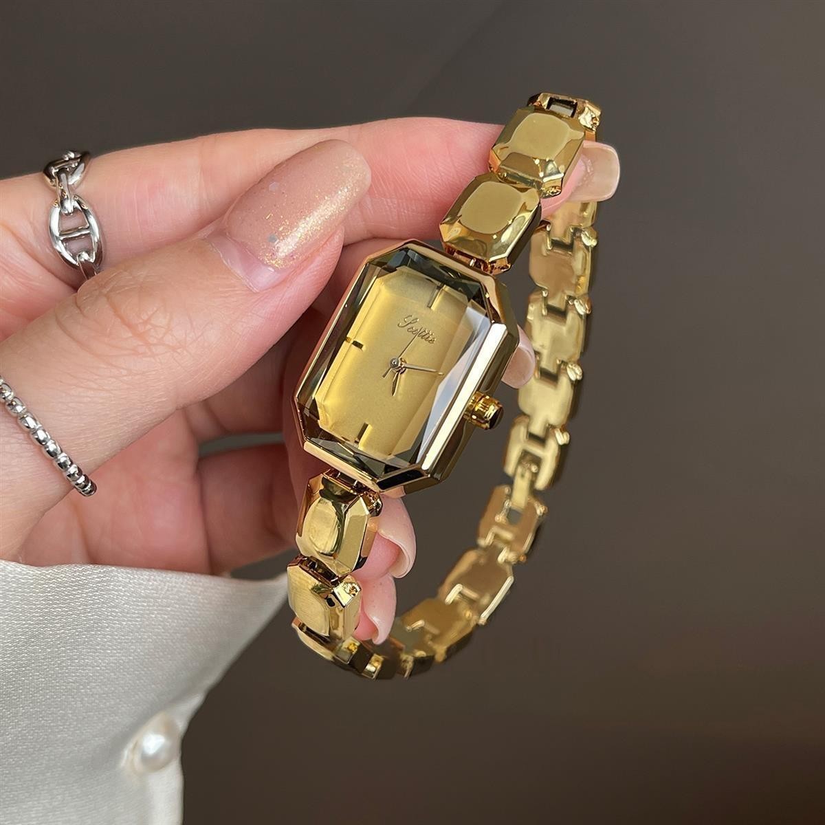 Elegant women's watch with small dial and metal strap